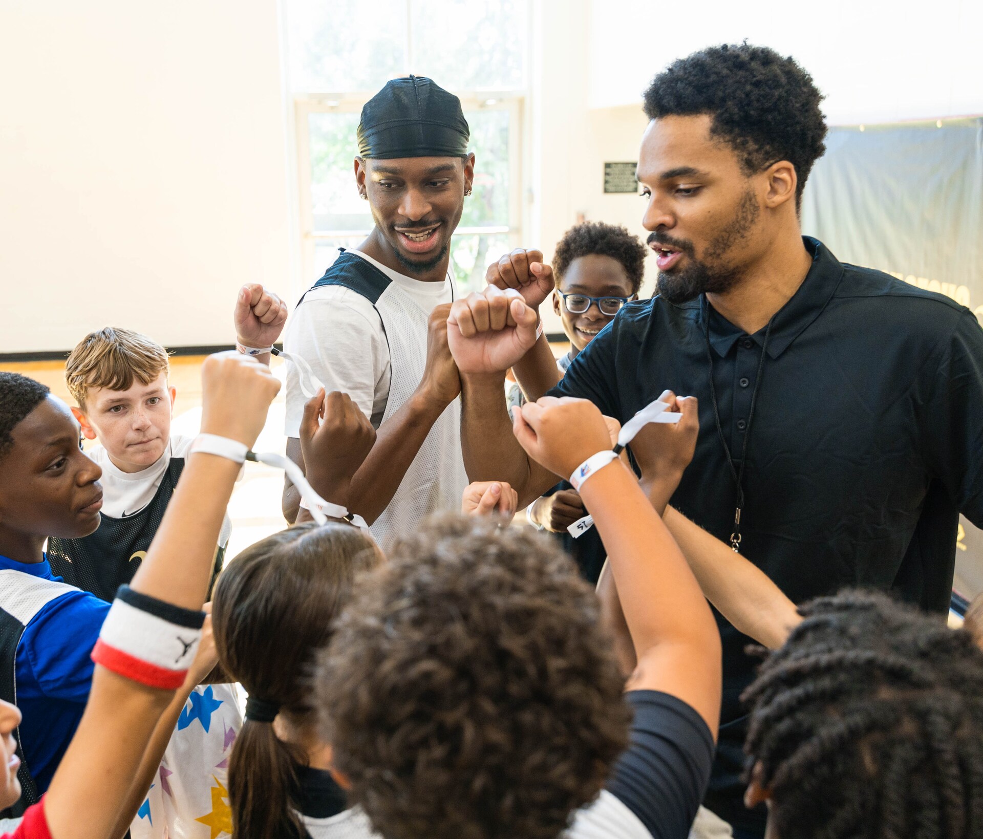 Young campers in a huddle at an SGA Foundation basketball camp